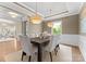 Formal dining room featuring elegant lighting fixtures, wainscoting, and a dark wood table at 541 Nw Sutro Forest Dr, Concord, NC 28027