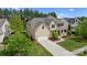 Beautiful two-story home featuring a manicured lawn, attached garage, and stone accents on a tree-lined street at 541 Nw Sutro Forest Dr, Concord, NC 28027