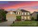 Charming two-story home with a well-manicured lawn, inviting front porch, and attached garage at 541 Nw Sutro Forest Dr, Concord, NC 28027