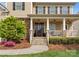 Inviting front porch with stone accents, pendant lighting, and a view of the landscaped front yard at 541 Nw Sutro Forest Dr, Concord, NC 28027