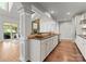 Open kitchen with stainless steel appliances, granite countertops, white cabinetry, and hardwood floors at 541 Nw Sutro Forest Dr, Concord, NC 28027