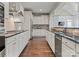 Spacious kitchen with stainless steel appliances, granite countertops, white cabinetry, and hardwood floors at 541 Nw Sutro Forest Dr, Concord, NC 28027