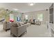 Bright living room with tree mural, plush seating, and ample natural light at 541 Nw Sutro Forest Dr, Concord, NC 28027