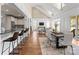 Open-concept living space featuring a kitchen with breakfast bar, dining area, and living room at 541 Nw Sutro Forest Dr, Concord, NC 28027