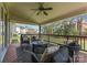 Covered back patio featuring comfortable seating, ceiling fan, and wooded backyard at 541 Nw Sutro Forest Dr, Concord, NC 28027