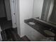 Bathroom featuring a granite countertop, dual sinks, and wood plank flooring at 574 30Th Avenue Ne Cir, Hickory, NC 28601