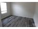 Bright bedroom featuring clean white walls, a new window, and stylish flooring at 574 30Th Avenue Ne Cir, Hickory, NC 28601
