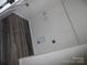 Functional laundry room with wood plank flooring and storage shelves at 574 30Th Avenue Ne Cir, Hickory, NC 28601