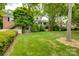 Well maintained backyard featuring a lush lawn, privacy fence, and mature trees at 5901 Quail Hollow Rd # G, Charlotte, NC 28210
