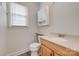 Half bathroom featuring a wood vanity, stone countertop, medicine cabinet, and modern fixtures at 5901 Quail Hollow Rd # G, Charlotte, NC 28210