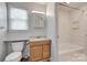 Nicely renovated full bathroom featuring a tiled tub shower and a wood vanity at 5901 Quail Hollow Rd # G, Charlotte, NC 28210