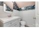 Updated powder room featuring wallpaper, wainscoting, and modern fixtures at 5901 Quail Hollow Rd # G, Charlotte, NC 28210