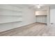 Bedroom featuring gray wood-look floors and built in shelving and closet space at 5901 Quail Hollow Rd # G, Charlotte, NC 28210