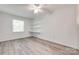 Bedroom with gray wood-look floors, white walls, and built-in shelving at 5901 Quail Hollow Rd # G, Charlotte, NC 28210