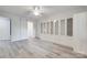 Spacious bedroom with built-in shelving, modern ceiling fan, and luxury vinyl plank flooring at 5901 Quail Hollow Rd # G, Charlotte, NC 28210