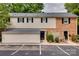 Charming townhome with brick and siding exterior, black shutters, and parking spaces at 5901 Quail Hollow Rd # G, Charlotte, NC 28210