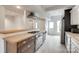 Modern kitchen with wood counters, stainless steel appliances, and updated gray wood-look floors at 5901 Quail Hollow Rd # G, Charlotte, NC 28210