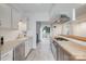 Updated kitchen featuring wood counters, stainless appliances, white cabinetry, and view to outdoor space at 5901 Quail Hollow Rd # G, Charlotte, NC 28210