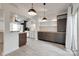 Open-concept living space with wood floors, view to kitchen, and sliding doors to patio at 5901 Quail Hollow Rd # G, Charlotte, NC 28210