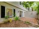 Outdoor patio and garden area with lush foliage and an attached home at 5901 Quail Hollow Rd # G, Charlotte, NC 28210