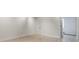 Bright room with neutral walls and wood-look flooring at 5901 Quail Hollow Rd # G, Charlotte, NC 28210
