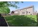 Backyard featuring a lush lawn, complimented by verdant trees and privacy fence at 6153 Kilchurn Dr, Fort Mill, SC 29707
