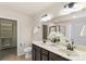 Bright bathroom features a double sink vanity, tile flooring and a walk-in closet in neutral tones at 6153 Kilchurn Dr, Fort Mill, SC 29707