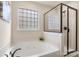 Modern bathroom with separate shower and tub, decorative tilework and a decorative plant for a relaxing ambiance at 6153 Kilchurn Dr, Fort Mill, SC 29707