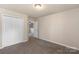 Bedroom with carpeted floors, double door closet and view into the hallway at 6153 Kilchurn Dr, Fort Mill, SC 29707