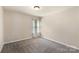Carpeted bedroom featuring warm interior design and a window for natural light at 6153 Kilchurn Dr, Fort Mill, SC 29707