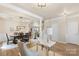 Bright dining and office area featuring wainscoting, hardwood floors, and decorative lighting at 6153 Kilchurn Dr, Fort Mill, SC 29707