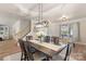 Dining room with dark wood table, seating for six, and modern light fixture at 6153 Kilchurn Dr, Fort Mill, SC 29707