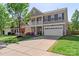 Attractive two-story home features a covered porch, stone detailing, and a spacious driveway for convenience at 6153 Kilchurn Dr, Fort Mill, SC 29707