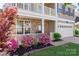 Inviting front porch with stone accents, fresh landscaping, and charming details enhances the home's appeal at 6153 Kilchurn Dr, Fort Mill, SC 29707