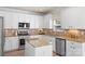 Beautiful kitchen with stainless steel appliances, island, and tile backsplash at 6153 Kilchurn Dr, Fort Mill, SC 29707