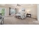 Serene main bedroom with a tray ceiling, soft lighting, and a view of the outdoors from a beautiful window at 6153 Kilchurn Dr, Fort Mill, SC 29707