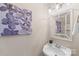 Charming powder room featuring a decorative mirror, unique artwork, and a stylish pedestal sink at 6153 Kilchurn Dr, Fort Mill, SC 29707