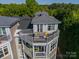 Condo upper level private balcony with outdoor seating and scenic views at 637 Williamson Rd # 309, Mooresville, NC 28117