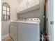Efficient laundry area with white washer and dryer set, and overhead cabinet space at 637 Williamson Rd # 309, Mooresville, NC 28117