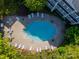 Aerial view of the community pool with lounge chairs and tables at 637 Williamson Rd # 309, Mooresville, NC 28117