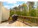 Wooden deck with a grill and views of surrounding trees and vegetation at 6702 Carradale Way, Charlotte, NC 28278
