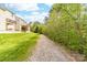 A serene backyard landscape features a pathway, lush green grass, and a privacy fence at 6702 Carradale Way, Charlotte, NC 28278