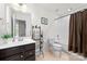 Bathroom features a vanity with storage, a tile floor, and a shower-tub combination with a curtain at 6702 Carradale Way, Charlotte, NC 28278