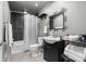 Well-maintained bathroom with tiled shower, patterned mirror, and under-sink storage at 6702 Carradale Way, Charlotte, NC 28278