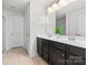 A well-lit bathroom features double vanity, a shower and a separate door for the toilet area at 6702 Carradale Way, Charlotte, NC 28278