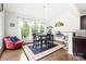 Bright dining area with large windows, hardwood floors, and contemporary furniture at 6702 Carradale Way, Charlotte, NC 28278