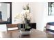 Close-up of a dining table with elegant floral decor and modern accents at 6702 Carradale Way, Charlotte, NC 28278
