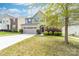Charming two-story home featuring stone accents, a well-maintained lawn, and a two-car garage at 6702 Carradale Way, Charlotte, NC 28278