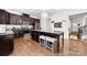 Well-equipped kitchen featuring dark cabinets, stainless steel appliances, and a spacious granite island at 6702 Carradale Way, Charlotte, NC 28278