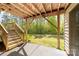 Outdoor patio below a wooden deck looks out onto the landscaped yard at 6702 Carradale Way, Charlotte, NC 28278